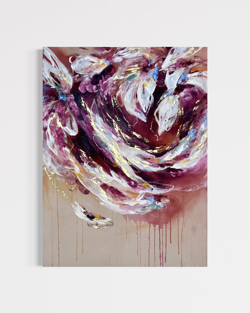 An abstract canvas painting featuring swirling patterns of deep purple, burgundy, white, and gold paint with dripping details on a light beige background, shown hanging on a neutral light gray wall.