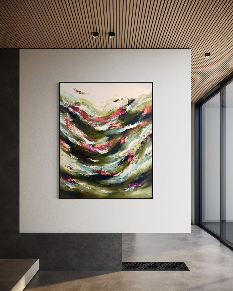 An abstract landscape painting with flowing green, beige, and pink brushstrokes, displayed in a modern interior hallway with a slatted wood ceiling and concrete floor.
